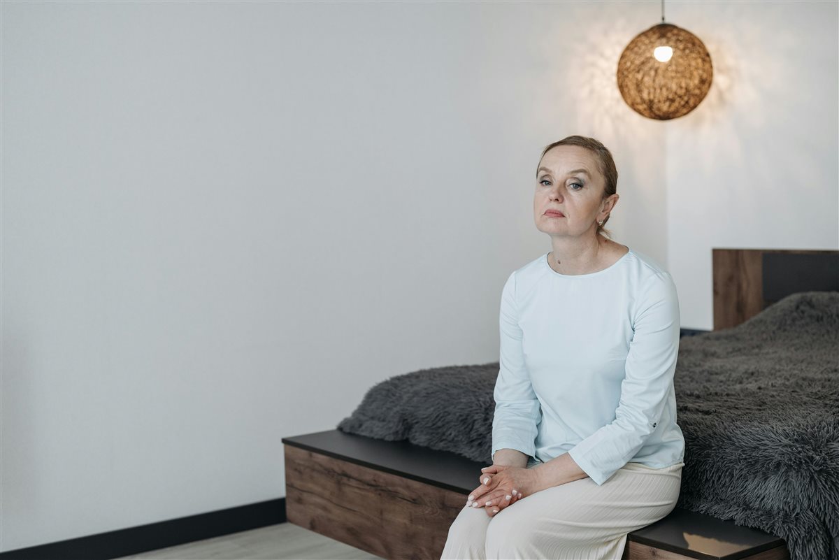 Woman sitting quietly, reflecting — the face of perimenopause ADHD unmasking